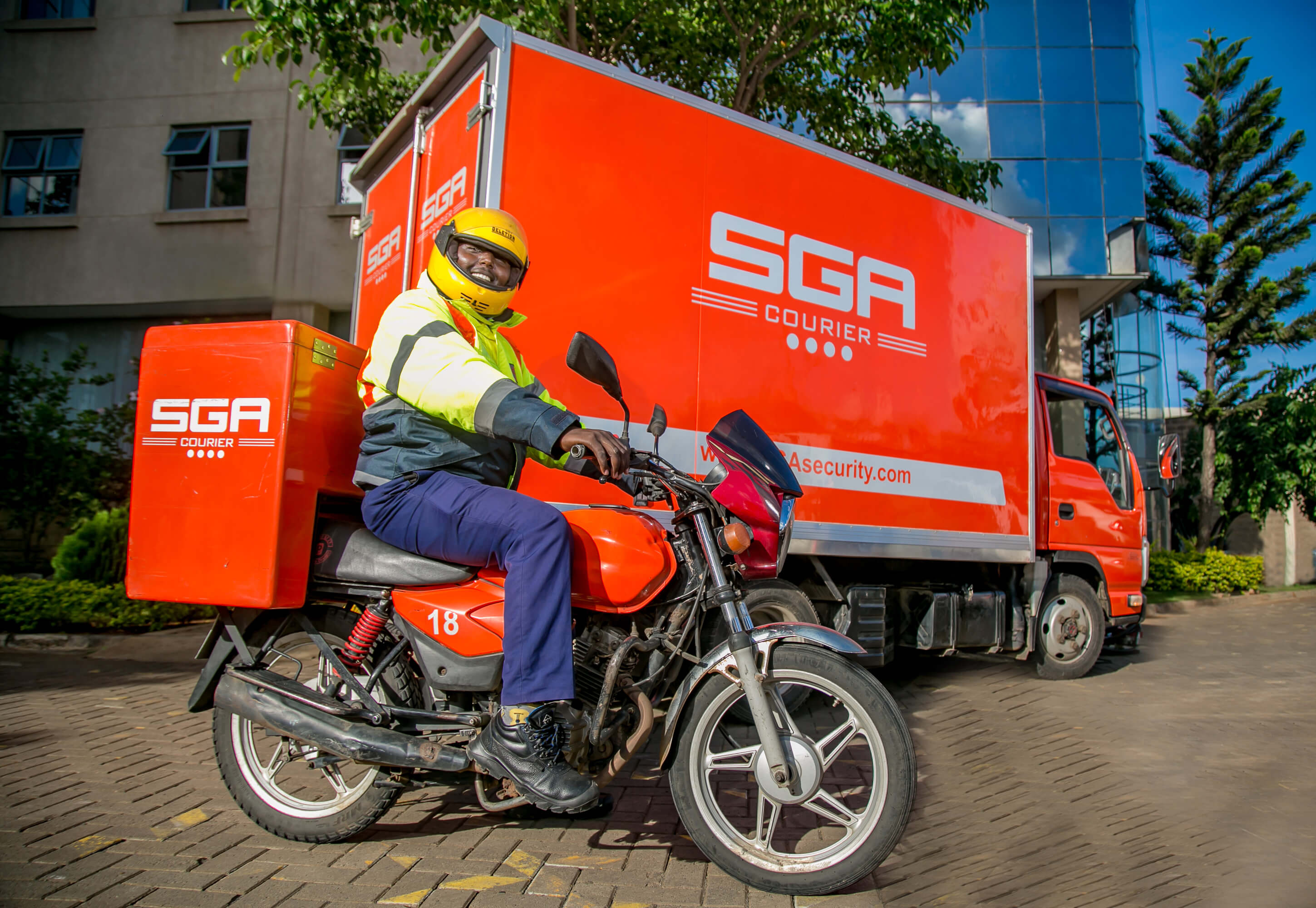 SGA delivery man riding a motorbike with packages for delivery